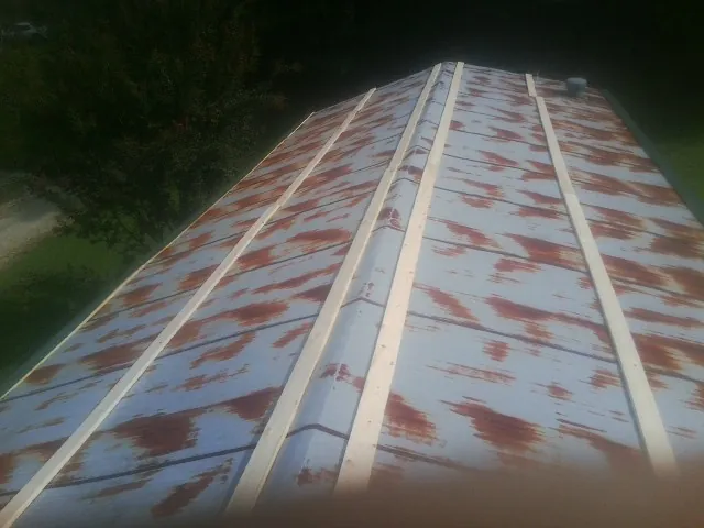 Rusted metal roof panels with new wood purlins before replacement — Storm Damage Roof Repair in Shelter Island by Roofing Brothers