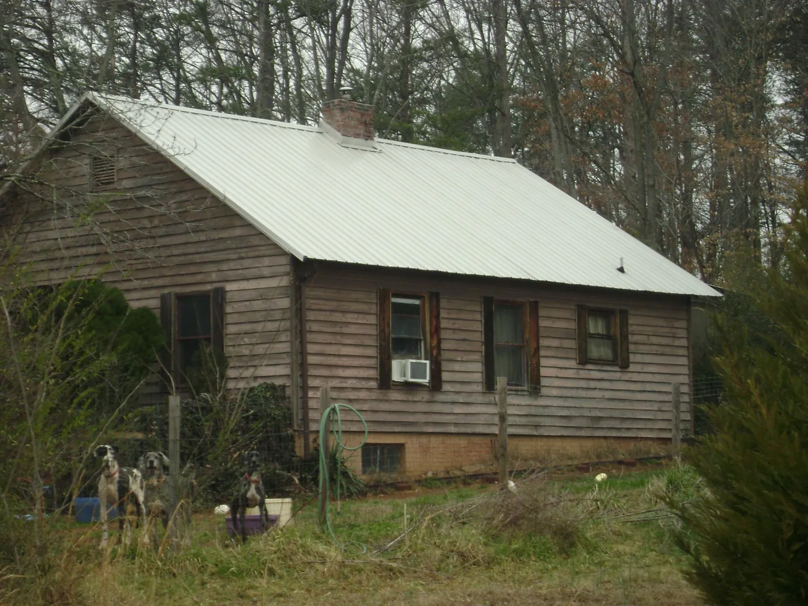 White metal roof on an old wood sided farmhouse, from a Asphalt Shingle Roof Repair job in Shelter Island